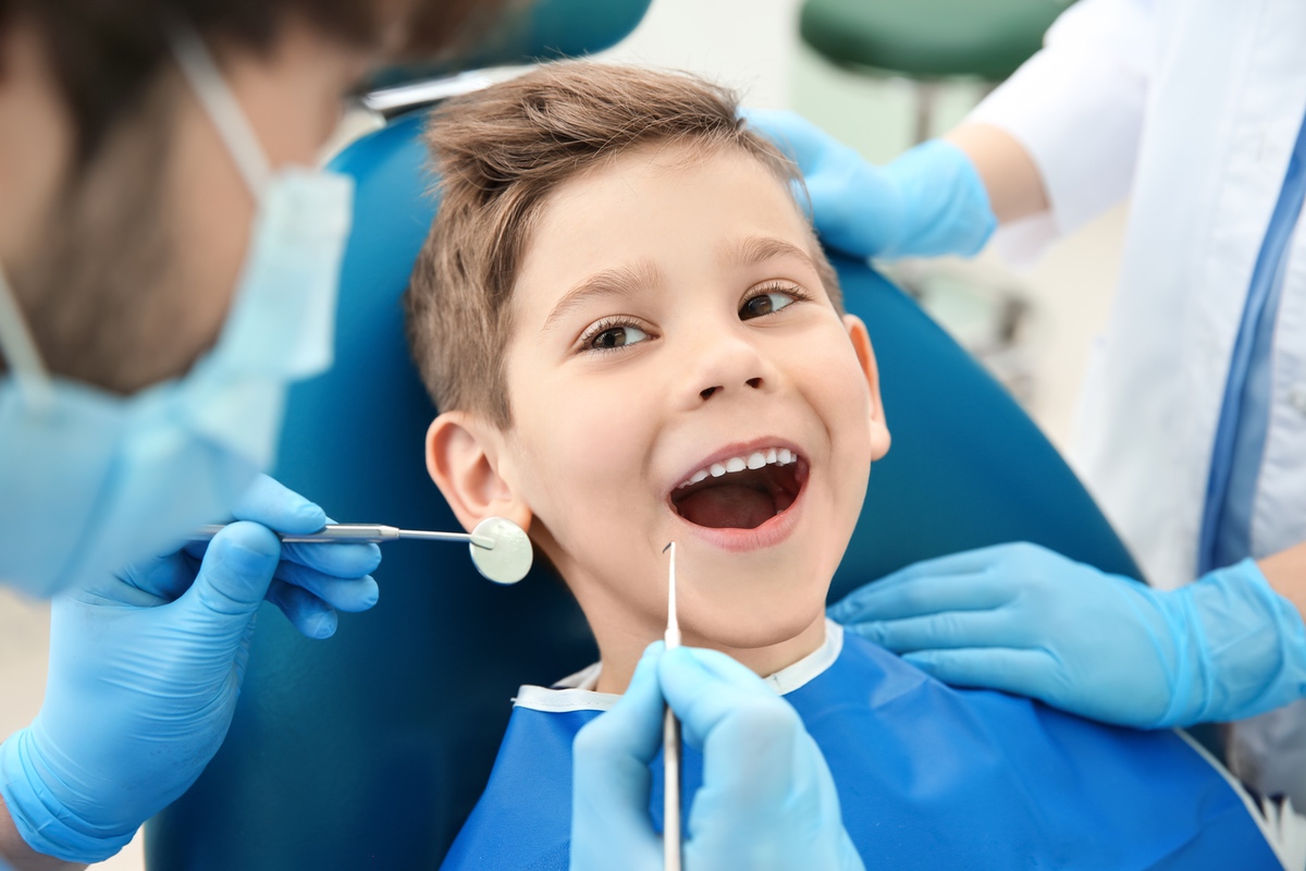 A dentist performing a dental procedure on a patient in Palm Desert, CA